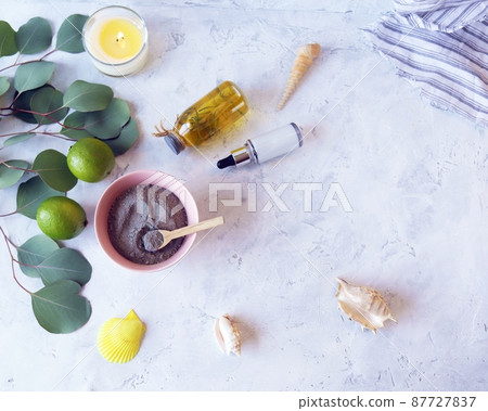 Blue clay, citruses, cream, aromatic oil, healthy tinctures and seashells on a light background, spa, natural ingredients, body care 87727837