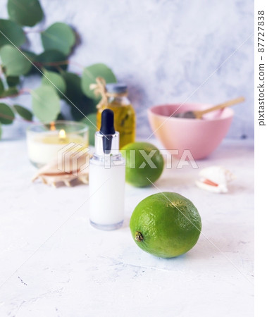 Blue clay, citruses, cream, aromatic oil, healthy tinctures and seashells on a light background, spa, natural ingredients, body care 87727838