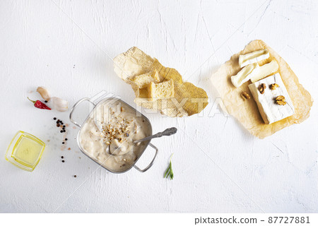 Melting camamber in pan with mushrooms, basil and garlic croutons, on a wooden table in rustic style 87727881