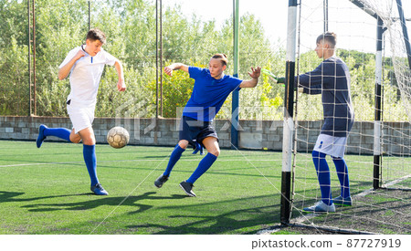 Football soccer players with ball. Footballers kicking football match on the pitch 87727919