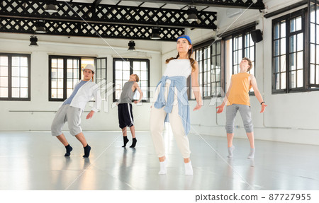 Team of young dancers training moves 87727955
