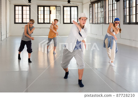 Group teenagers dancing hip-hop indoors 87728210