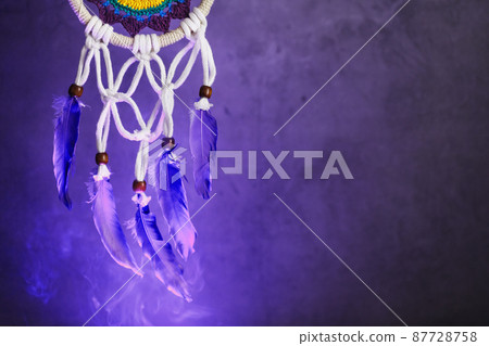 Dream catcher on a dark background with smoke and purple light Dream catcher on a dark background with smoke and purple light 87728758