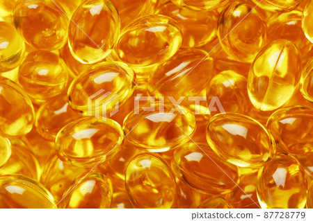 Golden Vitamin D3 Capsules close-up in full screen 87728779
