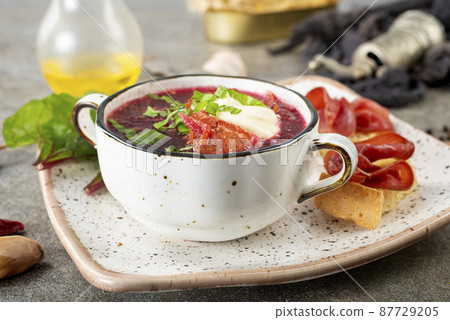 Traditional Ukrainian Russian borscht . Bowl of red beet root soup borsch with white cream . Beet Root delicious soup . Traditional Ukraine food cuisine Traditional Ukrainian Russian borscht . Bowl of red beet root soup borsch with white cream . Beet Root delicious soup . Traditional Ukraine food cuisine 87729205
