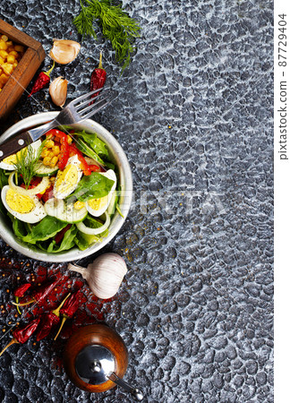 Salad of eggs and corn kernels with vegetables. Close-up 87729404