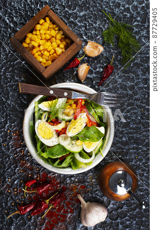 Salad of eggs and corn kernels with vegetables. Close-up 87729405