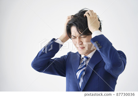 White background holding a businessman's head 87730036