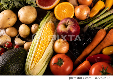 Full frame shot of corn with various fruits and vegetables on table 87730328