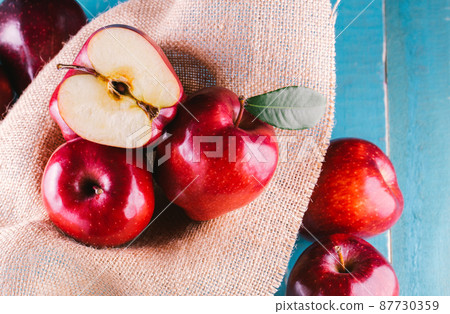 Ripe red apples on wooden background Ripe red apples on wooden background 87730359
