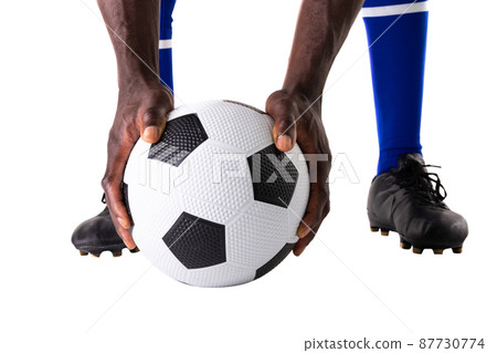 Low section of african american young male athlete holding soccer ball over white background Low section of african american young male athlete holding soccer ball over white background 87730774