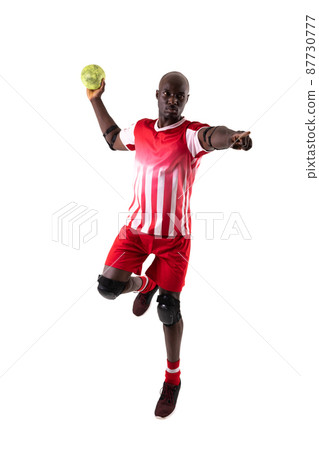Confident african american young male handball player throwing ball against white background Confident african american young male handball player throwing ball against white background 87730777