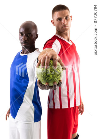 Portrait of confident male multiracial handball athletes holding green ball against white background Portrait of confident male multiracial handball athletes holding green ball against white background 87730794