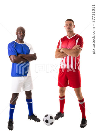 Full length portrait of confident biracial male soccer players with arms crossed on white background Full length portrait of confident biracial male soccer players with arms crossed on white background 87731011
