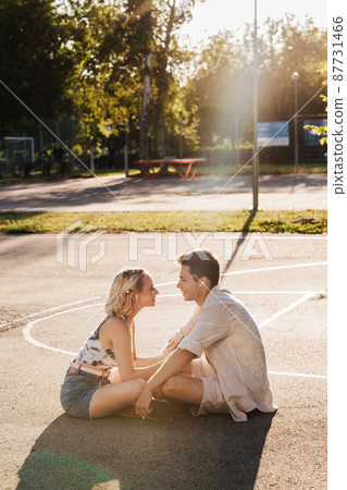 happy couple with earphones listening to music 87731466