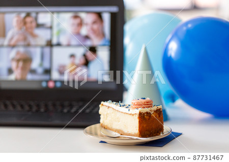 birthday cake and laptop with video call on screen 87731467