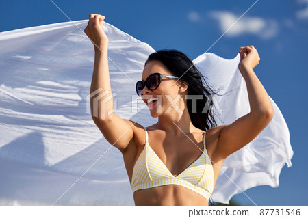 woman in bikini swimsuit with cover-up over sky 87731546