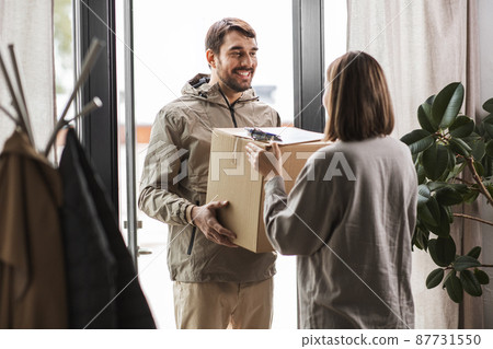 delivery man with parcel box and customer at home delivery man with parcel box and customer at home 87731550