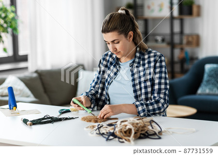 woman making macrame on table at home woman making macrame on table at home 87731559