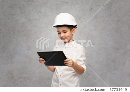 little boy in construction helmet with tablet pc 87731649
