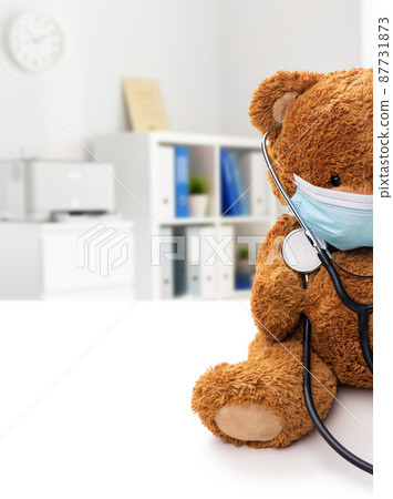 teddy bear toy in protective medical mask 87731873
