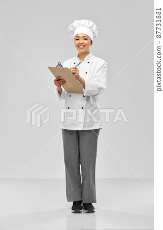 smiling female chef with clipboard and pen 87731881