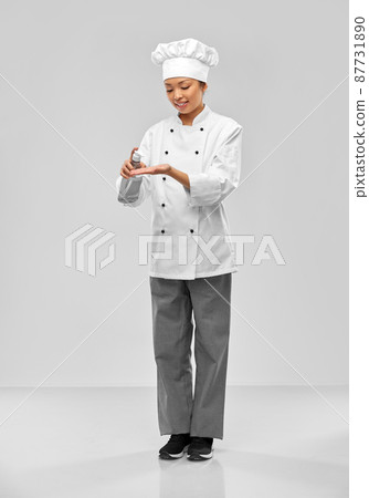 female chef applying hand sanitizer or liquid soap female chef applying hand sanitizer or liquid soap 87731890