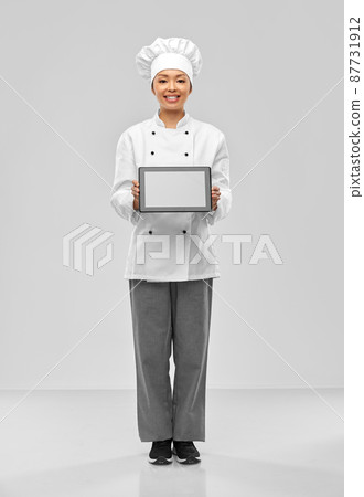 smiling female chef with tablet computer 87731912