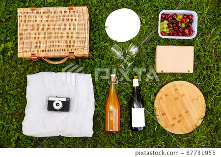food, drinks and picnic basket on grass food, drinks and picnic basket on grass 87731955