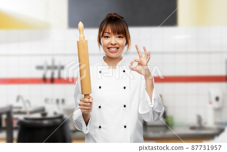 female chef or baker with rolling pin showing ok female chef or baker with rolling pin showing ok 87731957