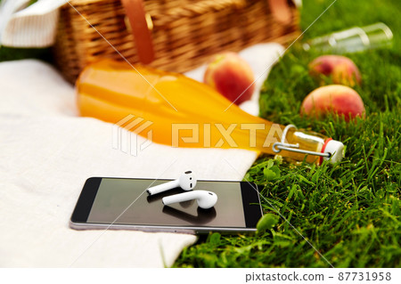phone, earphones, picnic basket and juice bottle phone, earphones, picnic basket and juice bottle 87731958