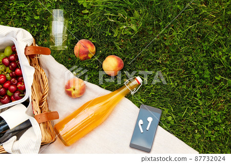 picnic basket, juice bottle, phone and earphones 87732024