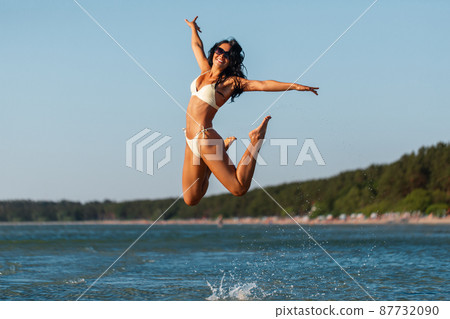 smiling young woman in bikini swimsuit on beach smiling young woman in bikini swimsuit on beach 87732090