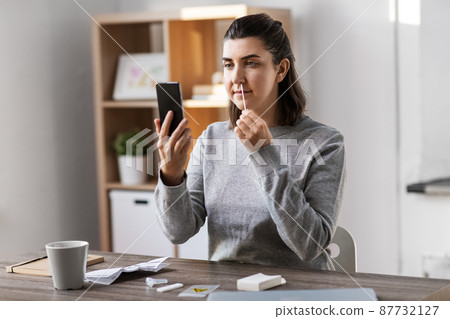 woman making coronavirus self test at home 87732127
