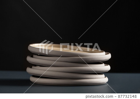 close up of ceramic plates on black table 87732148