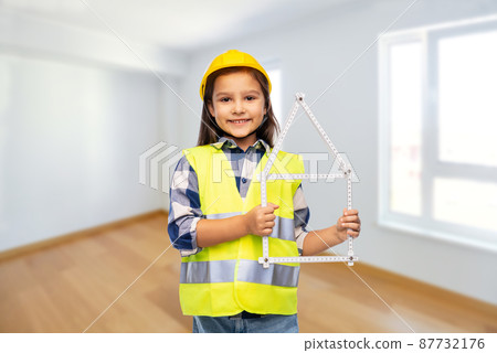 little girl in helmet with ruler in shape of house little girl in helmet with ruler in shape of house 87732176