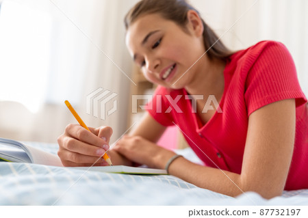 close up of teenage girl writing to diary at home 87732197