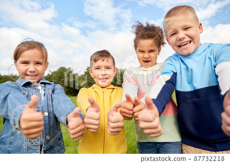 happy children showing thumbs up at park happy children showing thumbs up at park 87732218
