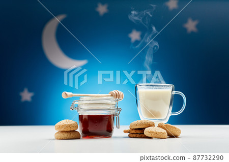 cup of hot milk, honey and cookies at night 87732290