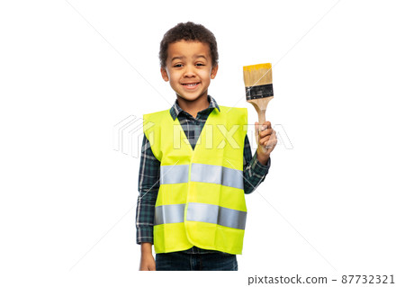 boy in helmet and safety vest with paint brush 87732321