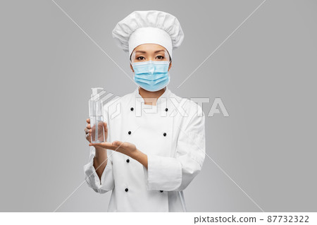 female chef in mask with hand sanitizer or soap female chef in mask with hand sanitizer or soap 87732322
