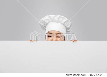 female chef peeking out from behind white board 87732346