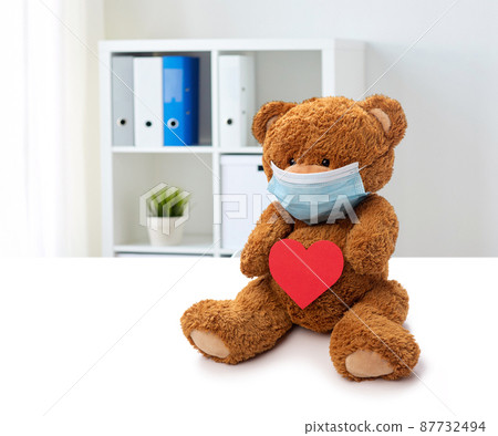 teddy bear in mask with red heart at clinic teddy bear in mask with red heart at clinic 87732494