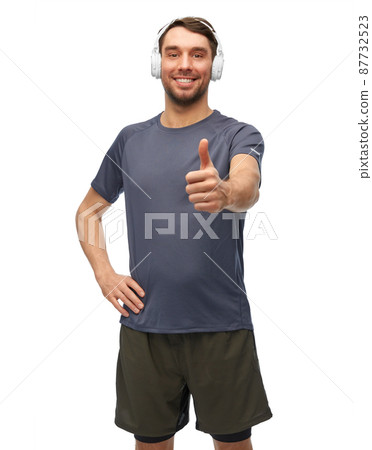 smiling man in sports clothes with headphones smiling man in sports clothes with headphones 87732523