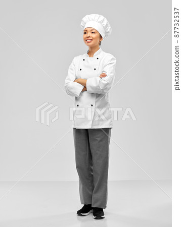 smiling female chef in white jacket 87732537