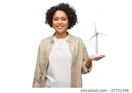 happy woman holding toy wind turbine 87732596