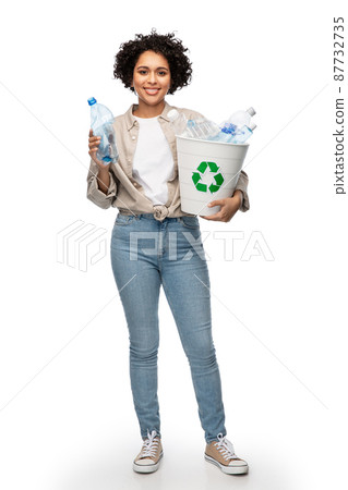 smiling young woman sorting plastic waste 87732735