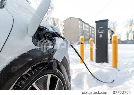 close up of electric car charging in winter 87732794