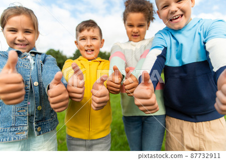 happy children showing thumbs up at park happy children showing thumbs up at park 87732911