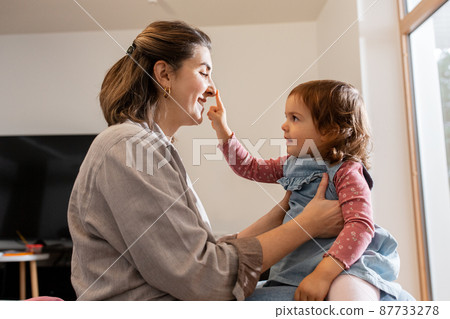 happy mother and daughter playing at home 87733278